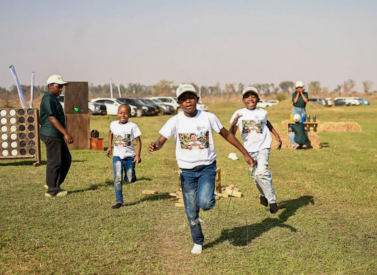 Children running on the grass during a Park City community event