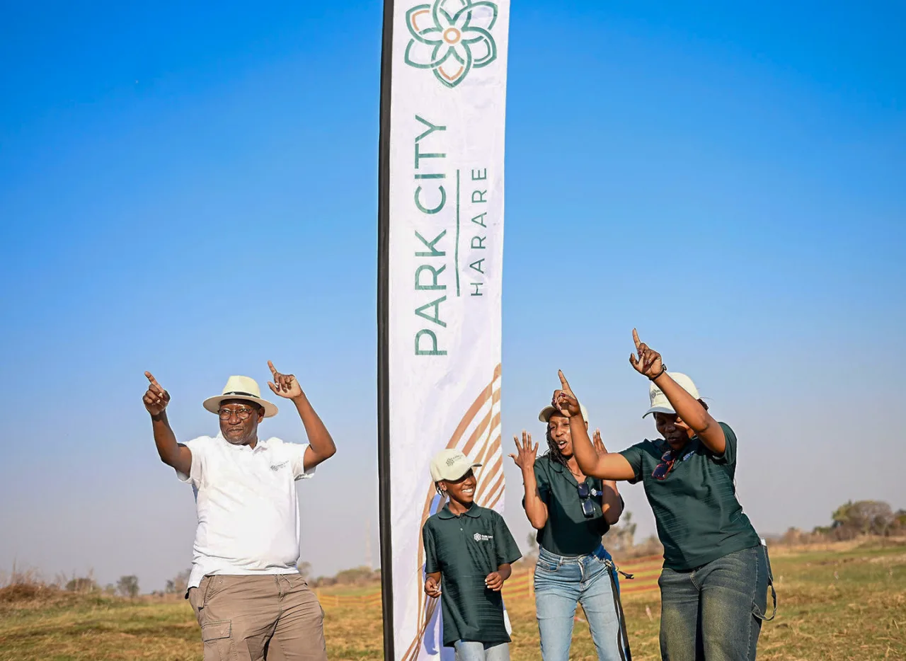 Guests celebrating beside the Park City Harare flag